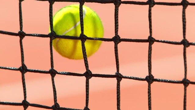 Super Slow Motion Shot of Tennis Ball Hitting the Net on Court at 1000fps.