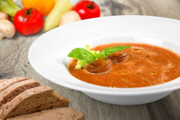 Bowl with tasty soup on wooden background