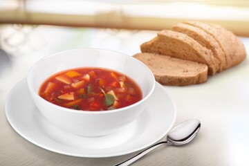 Bowl with tasty soup on wooden background