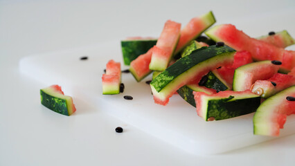 Close-up of watermelon peels on a white table, food leftovers, bio trash, summer ripe berry season,...