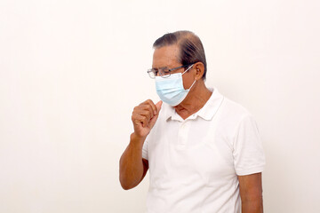Elderly asian man wearing face mask standing while coughing. Isolated on white with copyspace