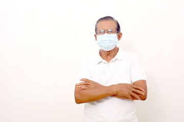 Asian man standing wearing face mask with folded hand. Isolated on white background with copyspace