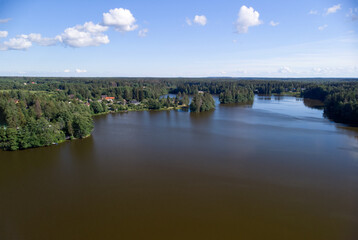 Fototapeta na wymiar Lakes of the Karelian isthmus aerial view. Leningrad region in summer. Peat lakes in a green forest.