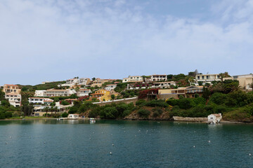 Fototapeta na wymiar Mahon (Mao), Minorca (Menorca), Spain. Port of Mahon - the largest natural port in the Mediterranean Sea. Small islands, fortifications, villas, boats make beautiful scenery. View from the cruise boat