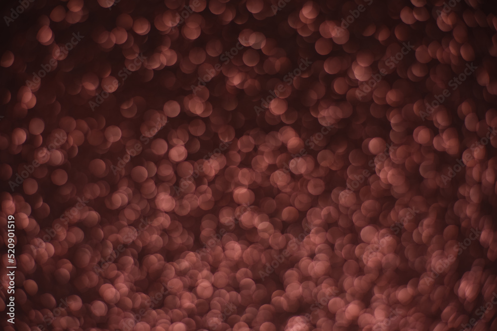 Wall mural abstract background of multi-layered brown bokeh on a dark background. lots of small brown glowing d