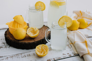 lemonade drink with yellow lemons or lime on Jar and glass  on white background in Latin America	