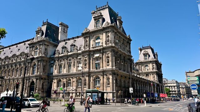 Paris, France, June 2022. Nice rear three-quarter footage of the City Hall, charming historic building along rue de rivoli. Pan movement, sunny day.