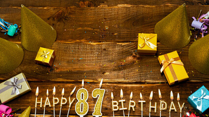 golden letters of the candle with the number happy birthday, the background of the gift boxes with...
