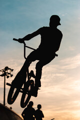Silhouette of acrobat cyclist on track