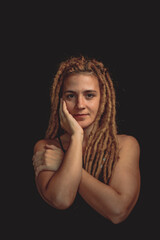 woman smiling to the camera with rasta hair