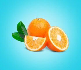 Orange with cut in half and leaves on the desk