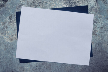 Top view of blank paper page on cement background with different objects. flat lay style