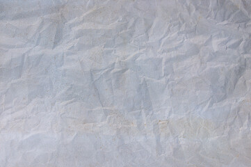Old pale white crumpled paper background texture.