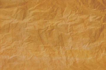 Old pale brown crumpled paper background texture.