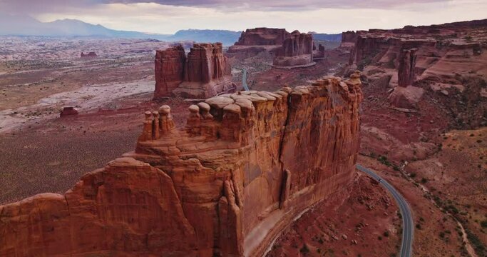 Weird rock formation of Bryce canyon in Utah, USA. Drone footage over the stunning rocks and highway crossing the dessert.