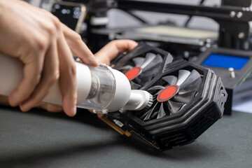 Cleaning the computer from dust and dirt with a vacuum cleaner, video card and computer CPU heatsink