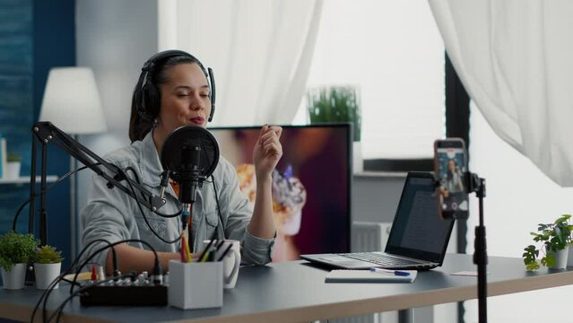 Friendly vlogger checking microphone while starting to record video for audience. Famous influencer talking at microphone with audience while telling life stories for daily vlog.