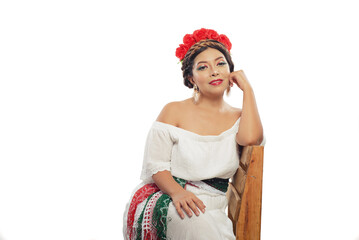 Mexican woman made up with the colors of the Mexican flag. Portrait of woman seated.