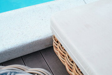 Corner of deck chair near swimming pool under sunlight. Exterior design. Resting in vacation on...