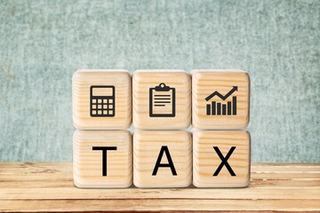 TAX concept, on wooden block on the desk