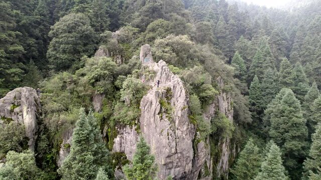 backwards drone shot of a climbing rock at south of mexico city