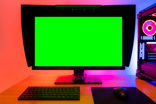 Professional workstation and gaming computer, to play video games online or do professional design and multimedia work. In a room with colorful neon led lights.