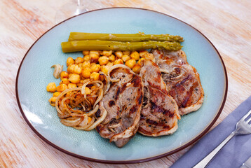 Lamb chop with chickpeas and asparagus closeup