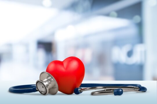 Red heart shape hand exercise ball with doctor physician's stethoscope. World heart health day. doctor day, world hypertension day