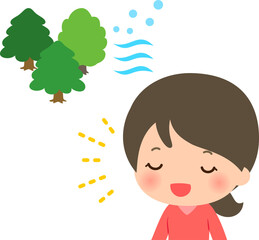 森林の涼しい風を浴びる女性