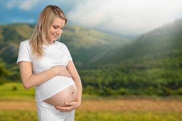 Pregnant woman during spring nature walk. Happy pregnancy outdoors active lifestyle