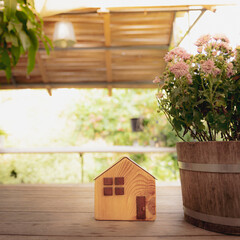 Wooden house model on  wood background, a symbol for construction , ecology, loan, mortgage,...