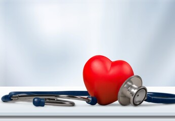 Red heart shape hand exercise ball with doctor physician's stethoscope. World heart health day....