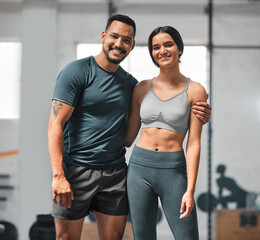 Happy, active and fit couple training, doing exercise and workout for fitness together at the gym. Portrait of a cheerful, joyful and content boyfriend and girlfriend at a sports center for cardio