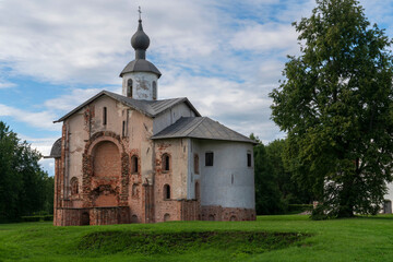 Fototapeta na wymiar View of the Church of St. Paraskevi (Paraskevy Pyatnitsy na Torgu) on the territory of Yaroslavovo Dvorishche on a cloudy summer day, Veliky Novgorod, Russia