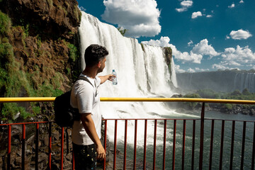 a traveler boy   looking  the waterfalls