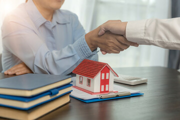 Estate agent shaking hands with client after contract signature and done business deal for transfer...