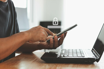 Asian businessman using the smart mobile phone to access on phone with laptop for validate password...