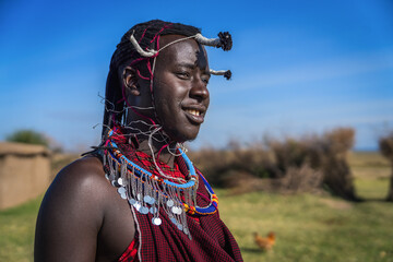 Portrait of Maasai mara man with traditional colorful necklace and clothing - obrazy, fototapety, plakaty
