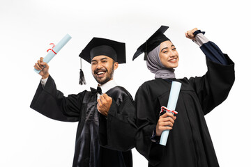 Excited female and male graduate students with clenched hands on isolated background