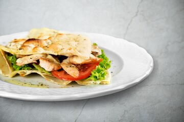 A tasty fresh sandwich with fresh vegetables on desk