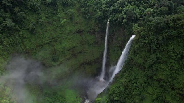 Tad Fane Waterfall, a picturesque twin set of waterfalls spilling over 100 meters down from the Bolaven Plateau in the jungle of Laos.
