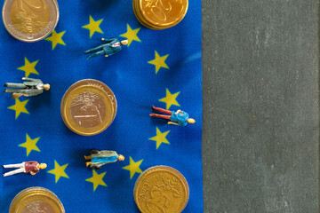 Taxpayers of EU countries concept.figurines of people and euro coins on european union flag...