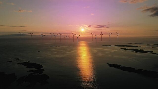 Aerial loop of a offshore wind energy farm, during sunset on the sea - 3d render
