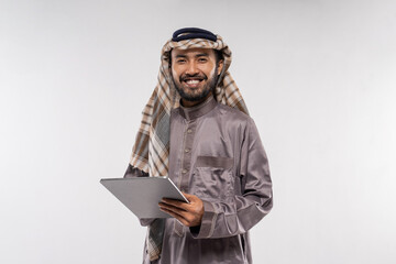 portrait of asian male with turban using a tablet against a plain white background