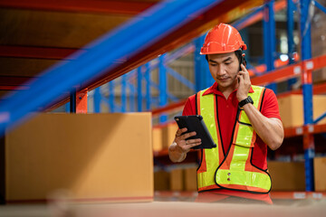 A young male worker inspects goods in a warehouse in a large warehouse. Products ready to be delivered to the distribution center Inventory management. Warehouses, warehouses, factories, industries