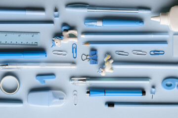 Background with various blue stationery lying diagonally on a light blue background. Back to school. A banner with office elements with space for text. Space for copying. Flat position, top view