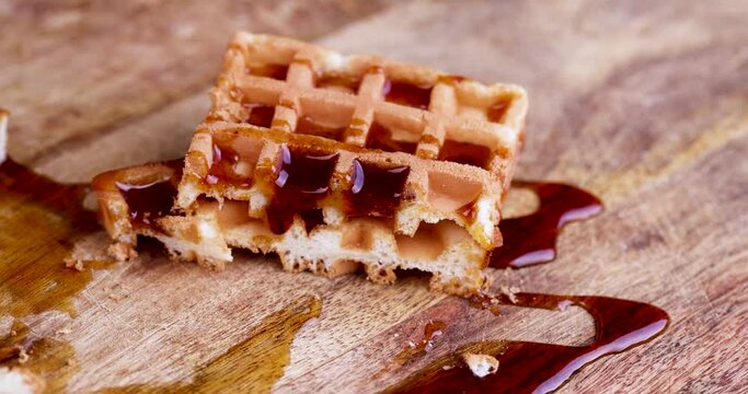 bee honey drips from the soft wiley during dessert cooking, making sweets from soft waffles and sweet bee honey