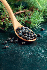 Wooden spoon with seeds of juniper.