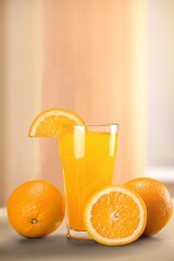 Fresh orange juice in a glass and half of orange fruit on the desk