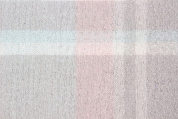 Fototapeta premium Warm woolen plaid close-up. Abstract textile background or texture. Winter cozy background for cold weather